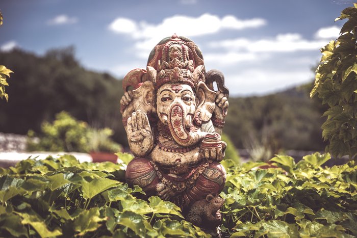 Eine Skulptur des Elefanten Gottes Ganesha zwischen vielen Pflanzen